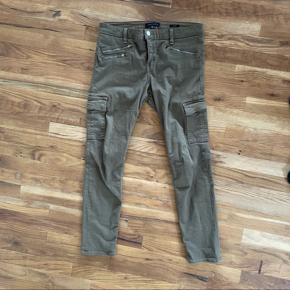 Olive green skinny jeans with side and zipper pockets